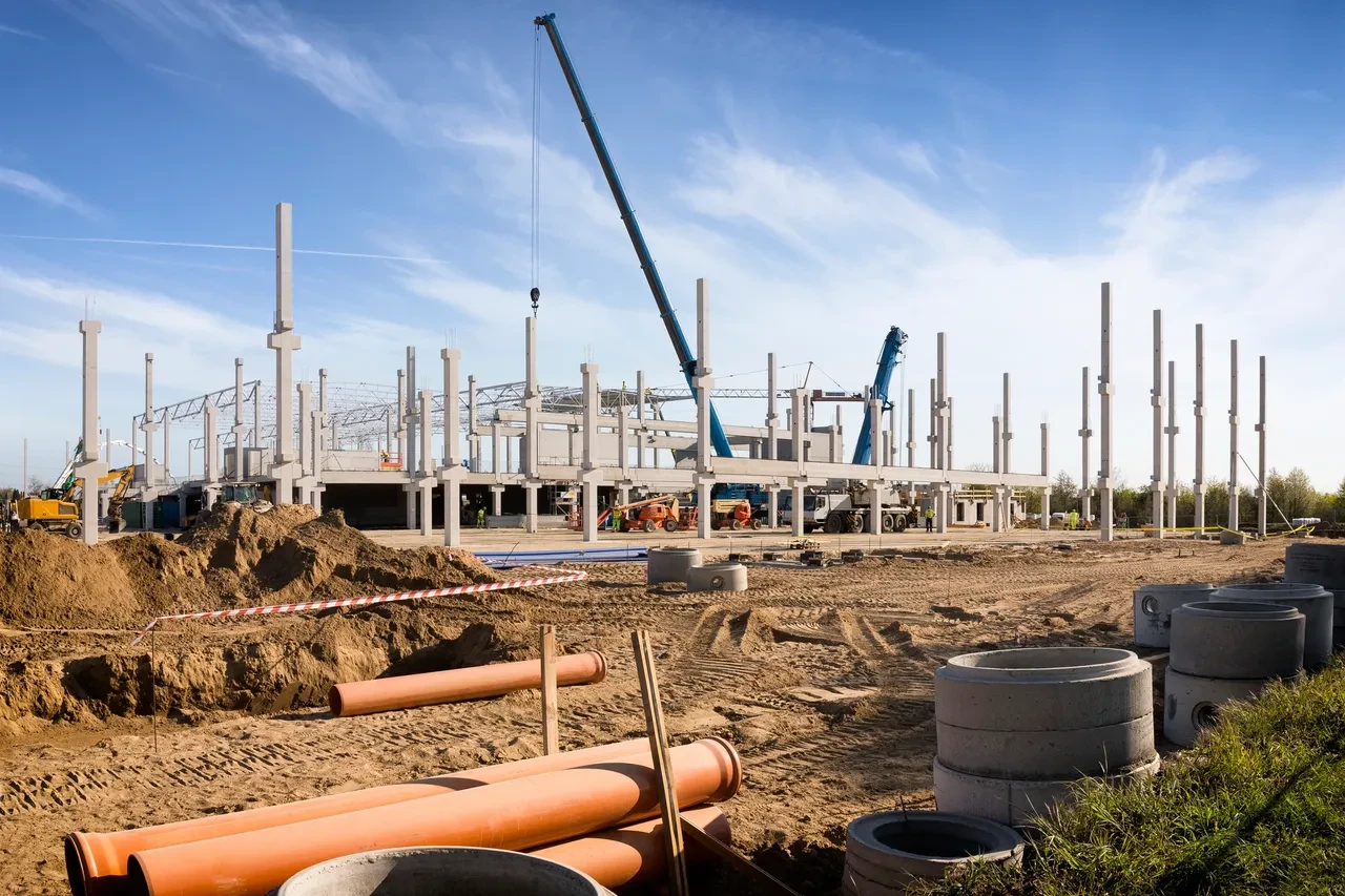 Commercial construction site with concrete columns and crane